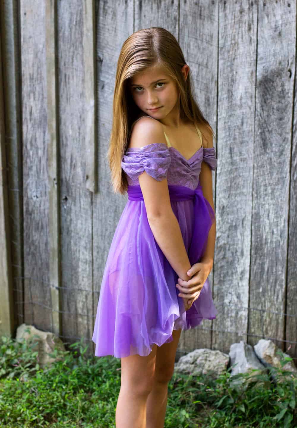 Lyrical dancer in a purple dress in a dance pose.
