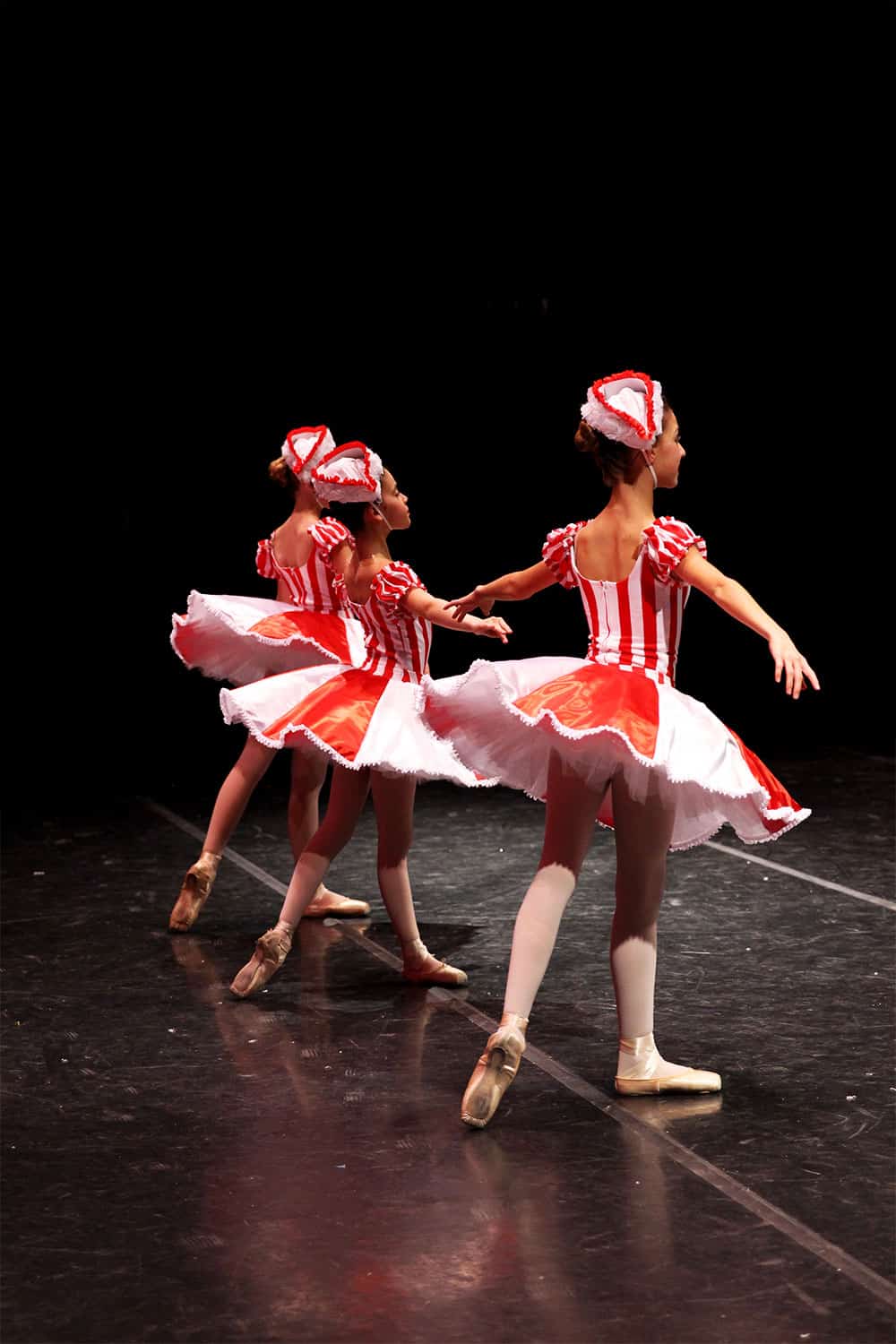 3 Marzipan dancers on stage in The Nutcracker Ballet.